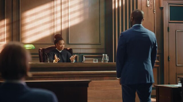 Court of Law and Justice Trial Proceedings: Male Law Offender is Questioned and Giving Testimony to Judge, Jury. Criminal Denying Charges, Pleading, Judge Accuses Guilty Defendant.