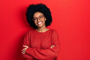 Fototapeta na wymiar Young african american woman wearing casual clothes and glasses happy face smiling with crossed arms looking at the camera. positive person.