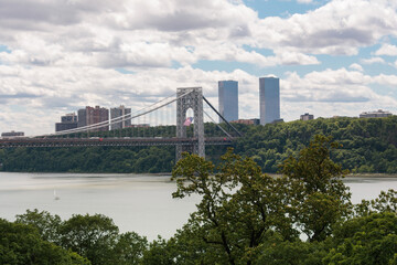 an American flag hangs from the New Jersey side suspension tower of the George Washington Bridge, a double deck suspension bridge connecting Manhattan to New Jersey across the Hudson River