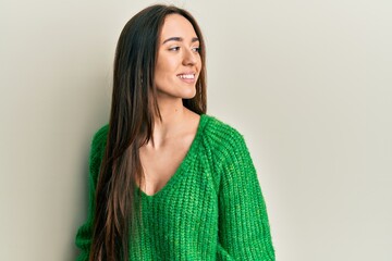 Fototapeta premium Young hispanic girl wearing casual clothes looking to side, relax profile pose with natural face and confident smile.