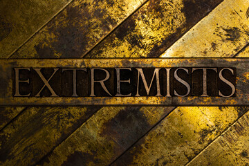 Extremists text message on vintage textured grunge copper and gold background