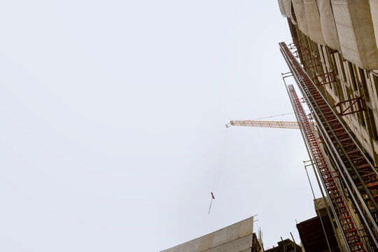 Construction crane and height building on white backgrounds