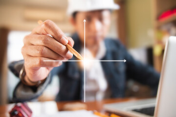 Engineer or Architect uses pencil pointing to X and Y axis for beginning construction development....