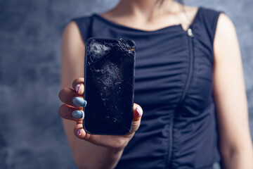 young girl holding broken phone