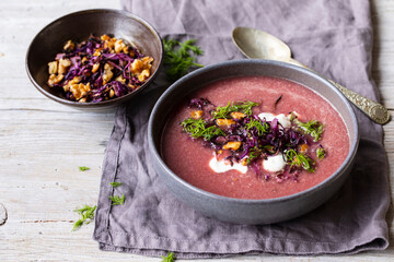 Red cabbage soup with crispy cabbage and walnuts topping