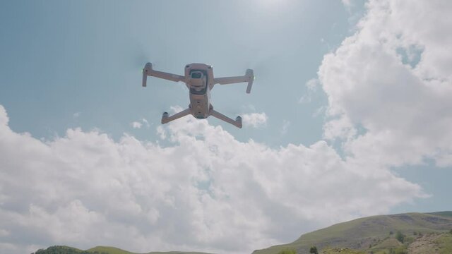 Quadcopter flying on background of mountains and sky. Action. Professional quadcopter for shooting while traveling. Quadcopter rises and takes pictures of mountain landscapes