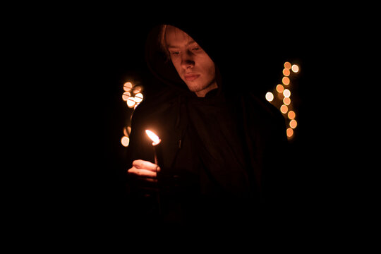 monk only one person hold candle with fire in warm darkness environment space faith concept soft focus photography