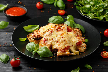 Baked Cauliflower steak with marinara sauce and cheese on plate. Healthy vegetarian food