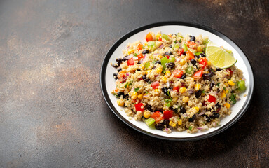 Quinoa black bean salad with corn, red green pepper, onion. Healthy food.