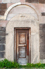Fototapeta na wymiar old wooden door in a stone wall