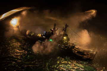 Silhouettes of a crowd standing at blurred military war ship on foggy background. Selective focus.