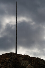 mast for flag in rock mountain with clouds background