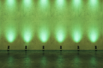 Front view on blank presentation wall in empty loft style hall illuminated by green lights. 3D...