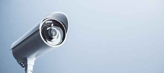 Wide close up image of cctv camera on light blue background with mock up place for your text and advertisement. Control system concept. 3D Rendering.