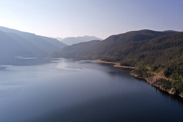 Aerial view of Lake Granby, Colorado and surrounding mountains and forests on clear calm summer morning.