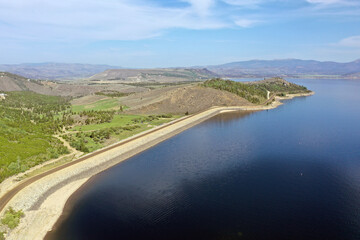 Aerial view of Lake Granby, Colorado and surrounding mountains and forests on calm sunny summer morning.