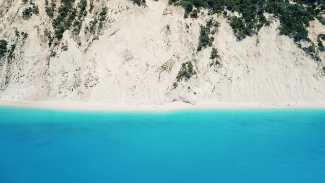 Drone shot of beautiful scenic beach with white sand and turquoise blue sea water, summer holiday in Greece, Egremni beach of Lefkada island.