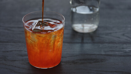 Making non alcohol spritz drink in a tumbler glass