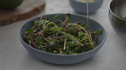 Micro greens in blue bowl to make salad