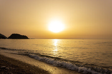 Beautiful view of seaside at dawn. Sunrise view with waves and sea. Landscape of rising sun over the sea in Cirali, Antalya, Turkey.