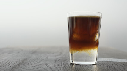 Making espresso tonic in tumbler glass