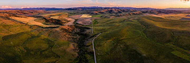 Southwest Montana foothills farmland fields patchwork panorama at sunset - Gallatin Valley -...