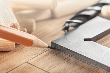 pencil, steel ruler drawing on wooden oak board for drilling holes