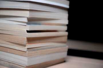 book stack on table with black background. 