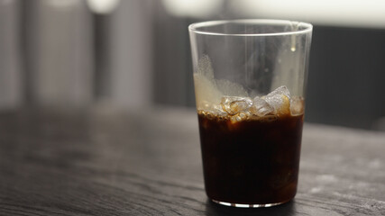 Making espresso tonic in tumbler glass, pour espresso in glass with crushed ice