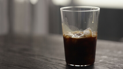 Making espresso tonic in tumbler glass, pour espresso in glass with crushed ice