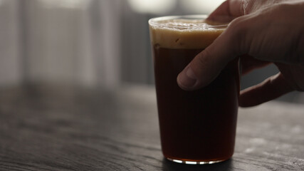 Making espresso tonic in tumbler glass, pour tonic