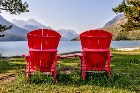 Adirondack chairs on the beach along the shores of Waterton Lake