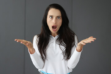 Portrait of young surprised woman with squint
