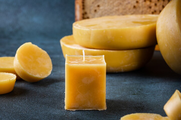 A handmade candle made of natural wax. Beeswax for homemade candles. Craft beeswax candle.