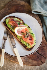 Flat-lay of healthy sourdough avocado toast with smoked salmon - 451086286