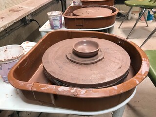 Ceramics clay pots drying on pottery wheel