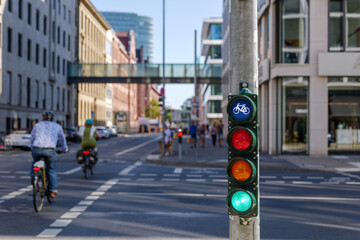 Selective focus, Green traffic light with bicycle symbol on sidewalk beside bicycle lane in Europe...