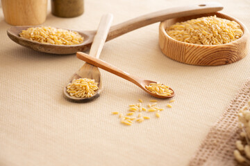 barley noodle wooden bowl and spoon on table