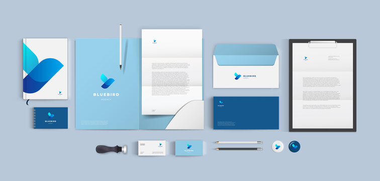 Top view stationery design mock up set for corporate identity or branding on table. Blue color style and grey background. Realistic bundle with folder, letter, envelope and business card.