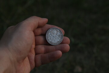 Old silver soviet coin half ruble in hand