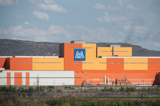 Magnitogorsk, Chelyabisk, Russia - 25 July 2021: New factory building of Magnitogorsk Metallurgical Mill with Russian logo "MMK"