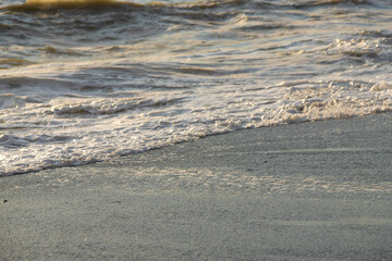 white sea foam near the shore close-up, waves