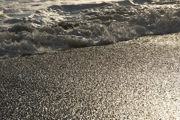 white sea foam near the shore close-up, waves