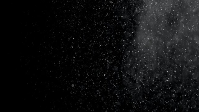 Rain Drops Falling on black background. Slow Rain, Sky Drops. Slow motion of raindrops. Footage is perfect for the layer with different blending modes.