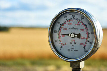 A close up image of an industrial pressure gauge used in the oil and gas industry.   