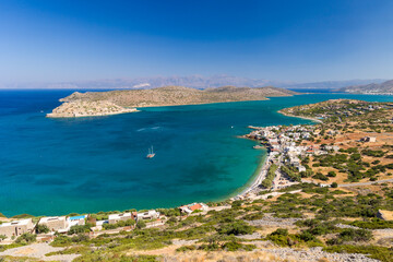 Fototapeta na wymiar Small Greek coastal village with beach and clear blue sea (Plaka, Elounda, Crete)