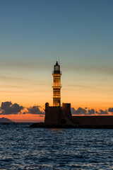 Old lighthouse at the ancient Venetian port of Chania (Greece) at dusk