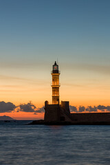 Ancient venetian lighthouse in the Cretan city of Chania at dusk