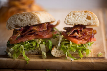 BLT sandwich. Bacon, Lettuce and Tomato Sandwich with fried eggs. Classic American Breakfast or Brunch menu item. Smoked bacon, beef steak tomatoes and lettuce on toasted whole wheat bread.
