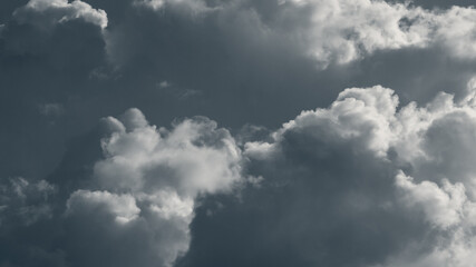 Dramatic rainclouds lit with bright sun, clouds in gray sky